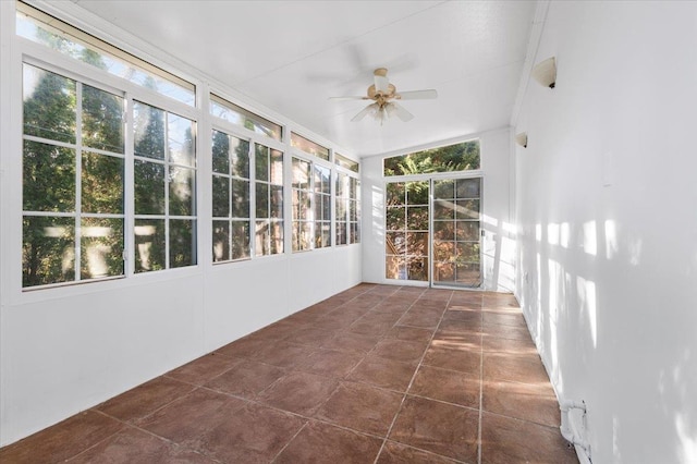 unfurnished sunroom featuring vaulted ceiling and a ceiling fan