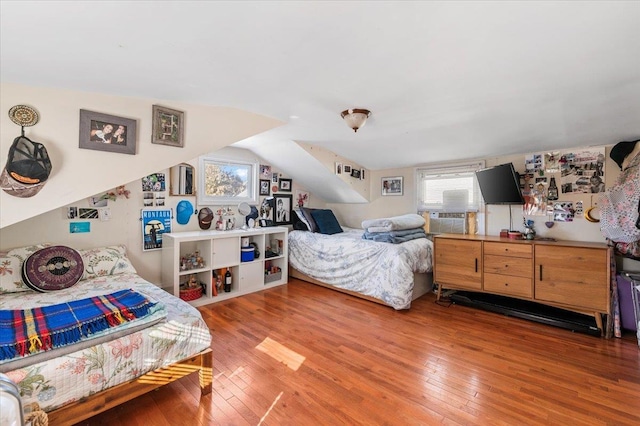 bedroom with hardwood / wood-style floors and vaulted ceiling