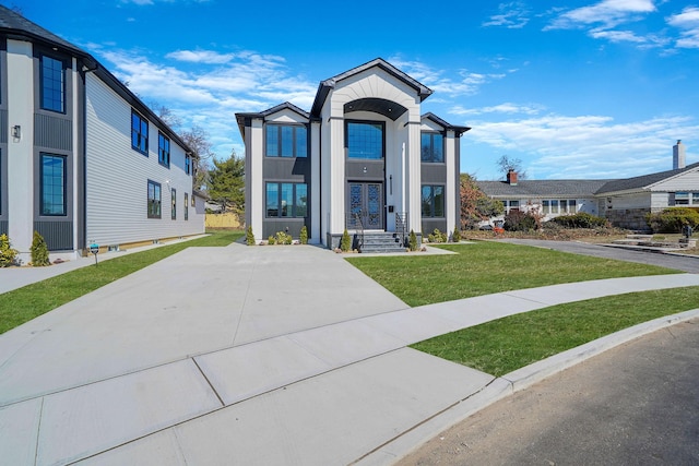 view of front of house featuring a residential view, stucco siding, and a front yard