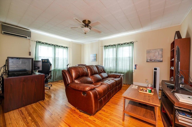 living area with light wood-style flooring, plenty of natural light, a wall mounted air conditioner, and ornamental molding