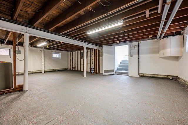 basement with concrete block wall and stairs