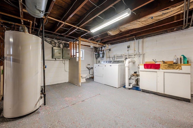 basement featuring gas water heater, electric panel, separate washer and dryer, and a sink