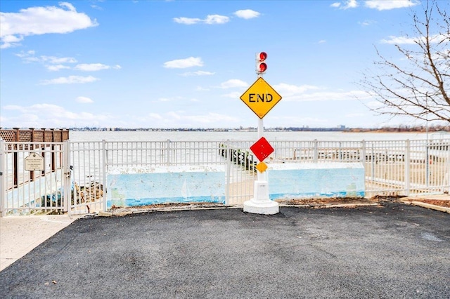 exterior space with a water view and fence