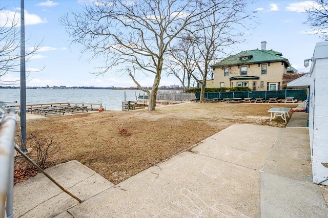 view of yard with fence and a water view