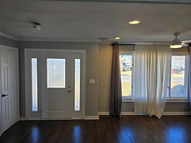 foyer entrance featuring visible vents, baseboards, dark wood-style floors, and ornamental molding