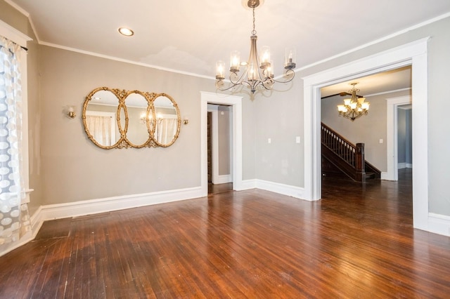 empty room featuring baseboards, stairs, hardwood / wood-style flooring, crown molding, and a chandelier