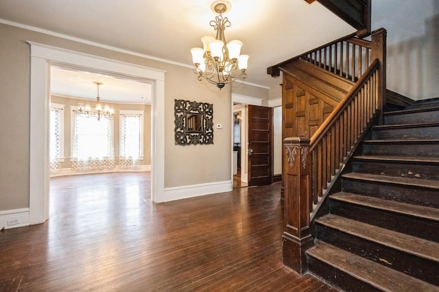 staircase with a notable chandelier, crown molding, baseboards, and hardwood / wood-style floors