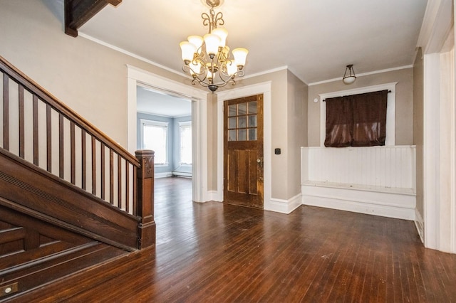 foyer with crown molding, baseboards, stairway, a notable chandelier, and wood-type flooring