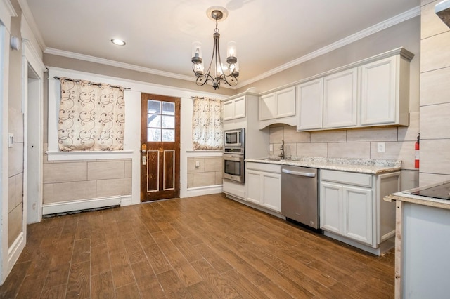 kitchen featuring dark wood-style floors, an inviting chandelier, ornamental molding, appliances with stainless steel finishes, and tasteful backsplash