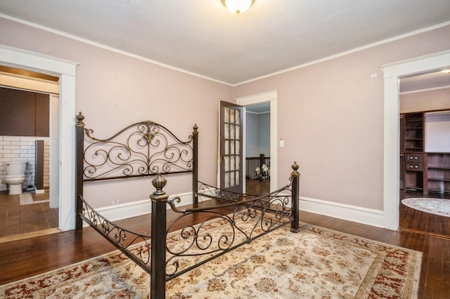 bedroom with wood finished floors, baseboards, and ornamental molding