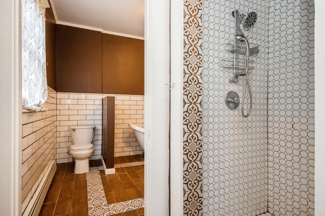 bathroom with a baseboard heating unit, tile walls, crown molding, and tiled shower