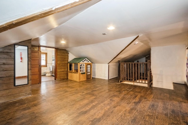 additional living space featuring hardwood / wood-style flooring and vaulted ceiling