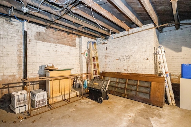 unfinished basement featuring brick wall