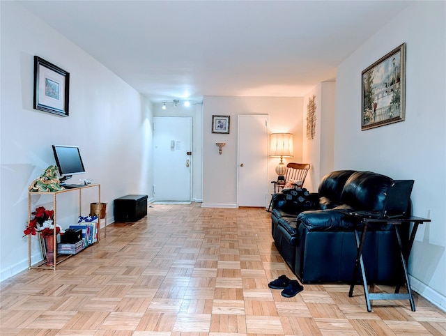 living area featuring baseboards