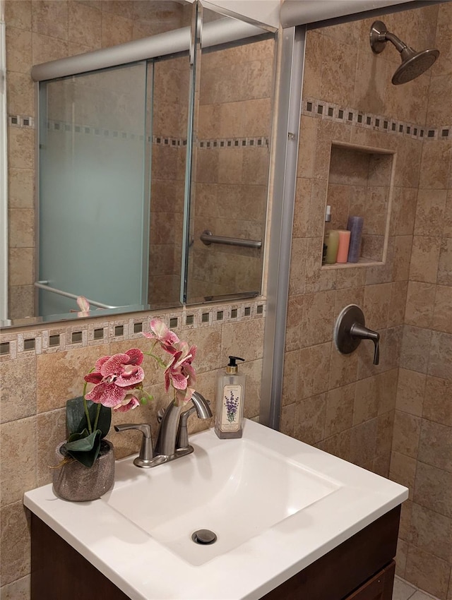 full bathroom featuring tile walls, a tile shower, and backsplash