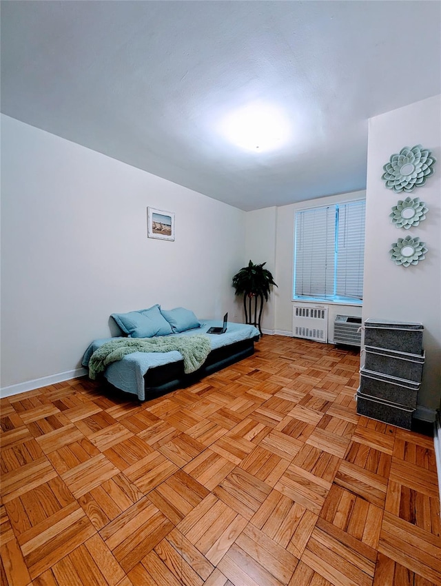 bedroom with radiator heating unit and baseboards