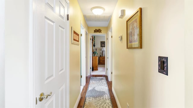 hallway featuring visible vents and baseboards