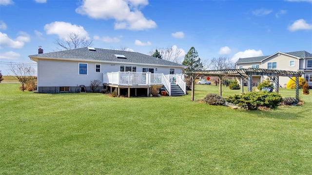 rear view of property with a lawn, a pergola, roof with shingles, a wooden deck, and a chimney