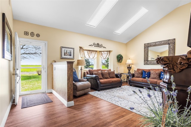 2100 Duck Pond Rd, Cutchogue, NY 11935 - living area featuring wood finished floors, lofted ceiling, and baseboards