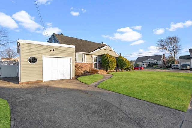 ranch-style home with an attached garage, driveway, a front lawn, and fence