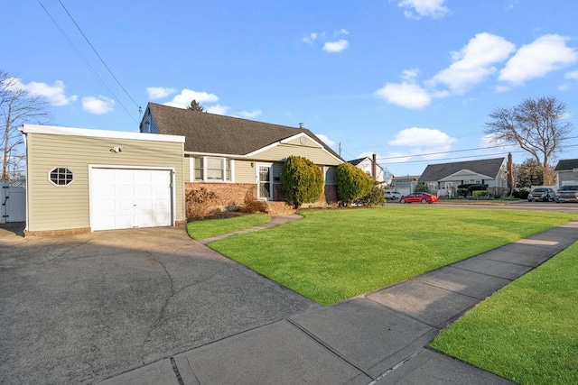 ranch-style house with a front yard, brick siding, a garage, and driveway