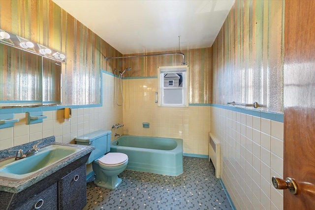 bathroom featuring plenty of natural light, toilet, and tile walls