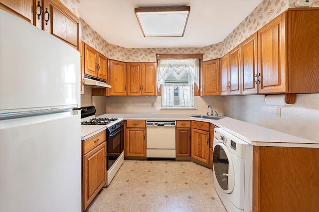 kitchen featuring white appliances, light floors, washer / clothes dryer, a sink, and under cabinet range hood