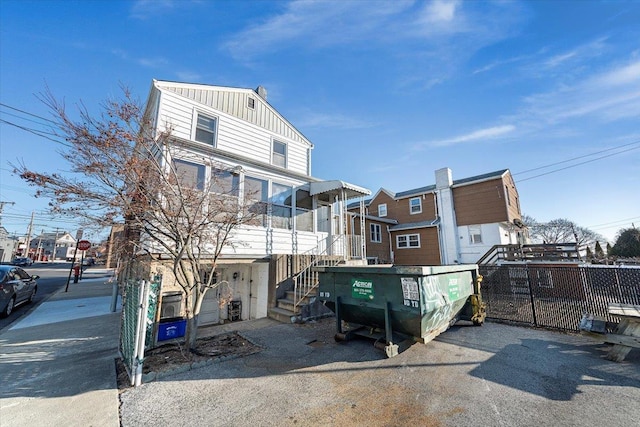 exterior space featuring board and batten siding and fence