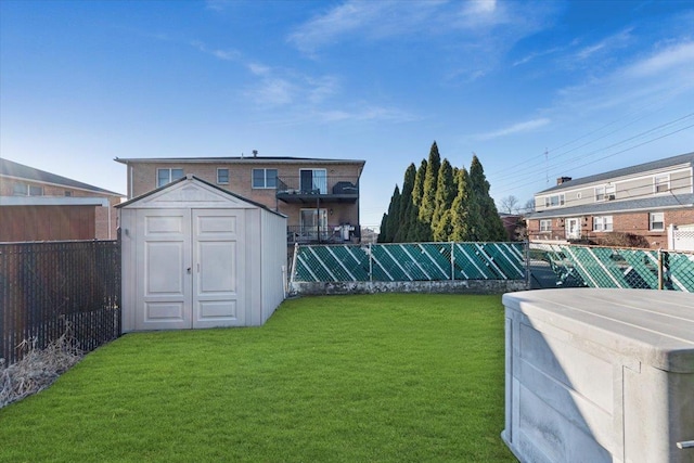 view of yard with an outbuilding, a shed, and fence