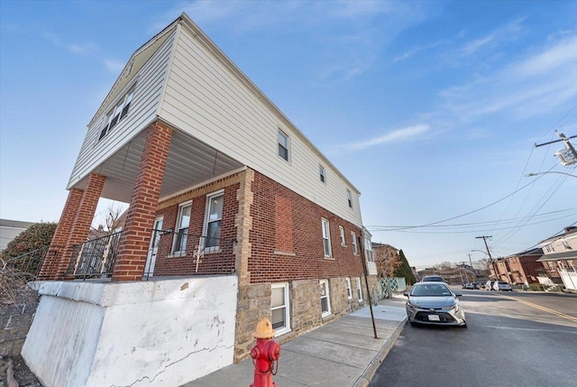 view of side of home with brick siding