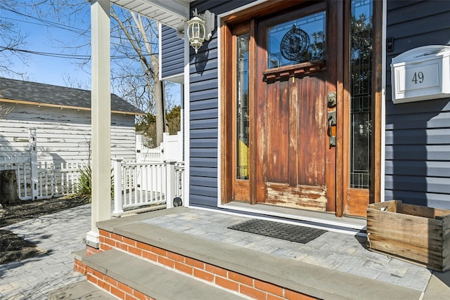 property entrance with a shingled roof