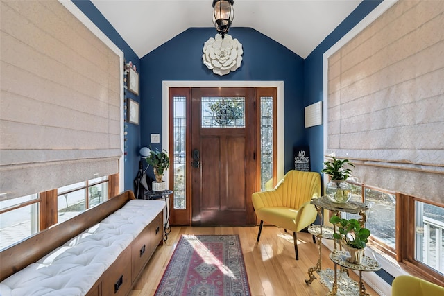 foyer with lofted ceiling and light wood-style flooring