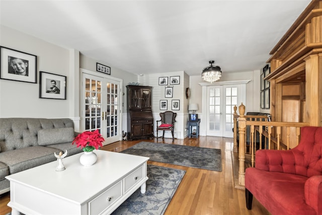 living room with french doors and hardwood / wood-style flooring