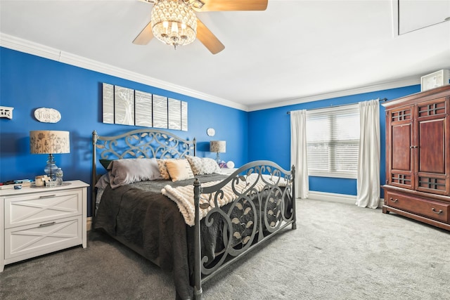 carpeted bedroom featuring baseboards, ornamental molding, and a ceiling fan