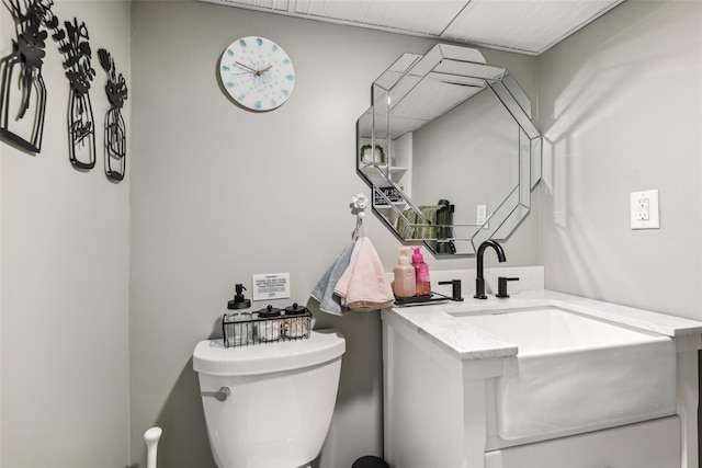 bathroom featuring toilet and vanity