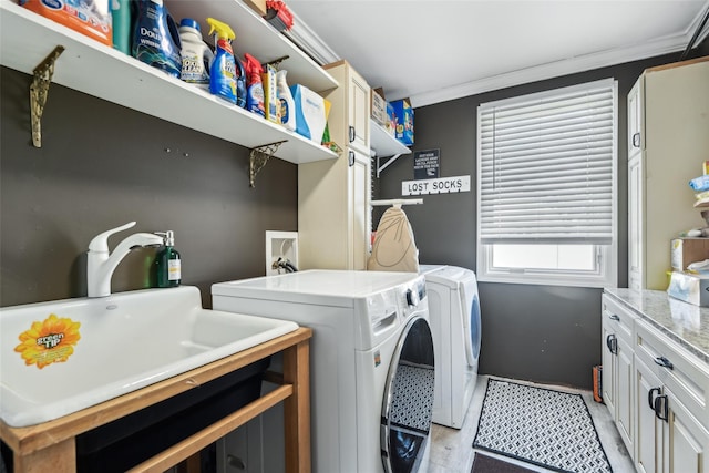 laundry room with washing machine and clothes dryer, cabinet space, light wood finished floors, and ornamental molding