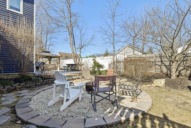 view of patio featuring a gazebo and a fenced backyard