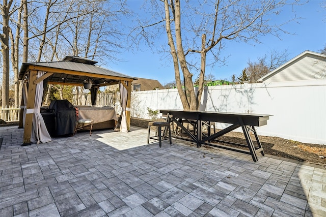 view of patio with a gazebo, a fenced backyard, and outdoor dining space