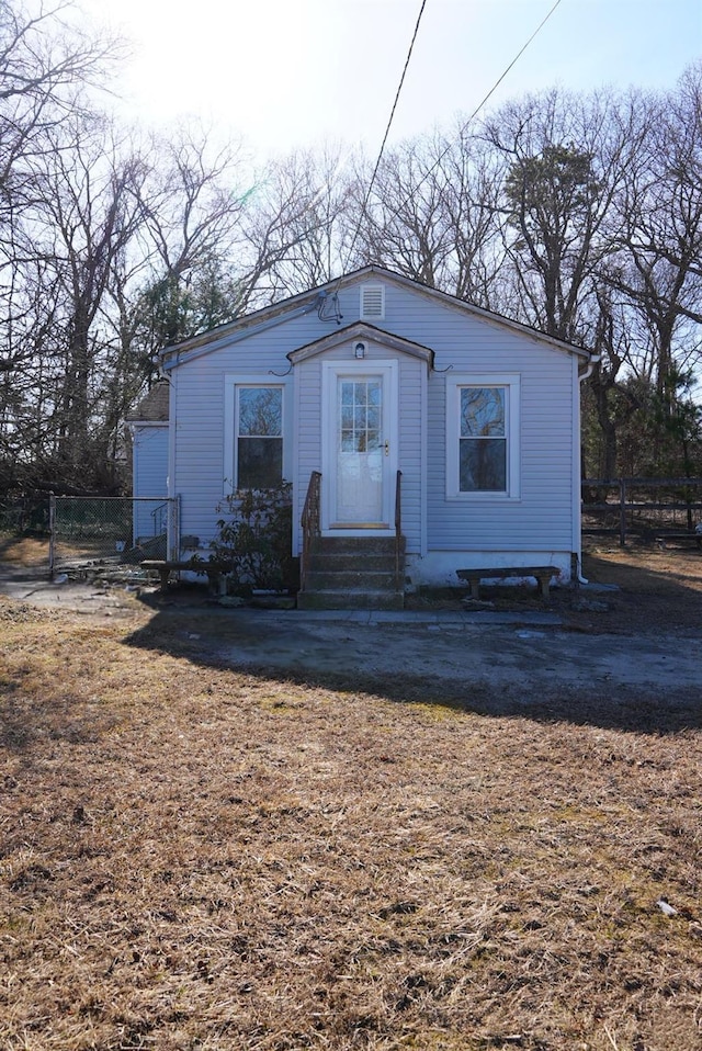 view of front facade featuring entry steps and fence