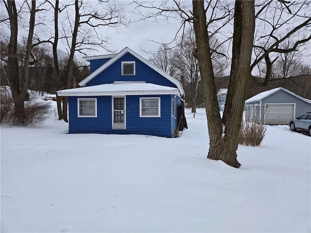 view of front of property featuring an outbuilding and a garage