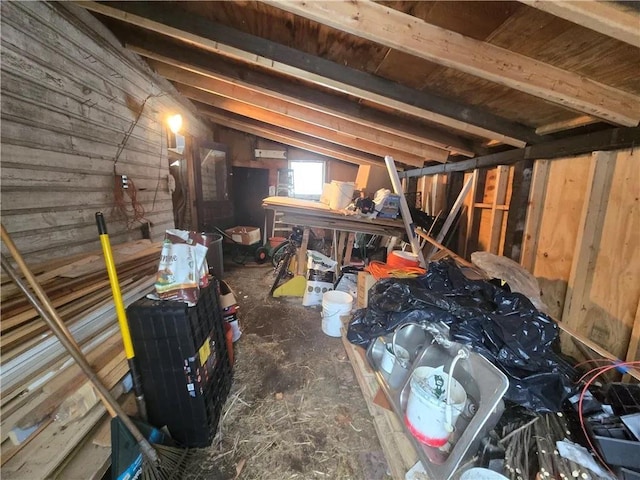 interior space with wood walls and lofted ceiling