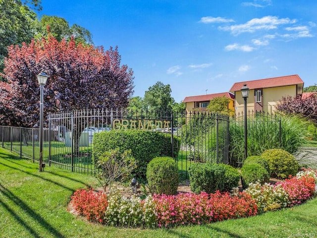 exterior space featuring a lawn and fence