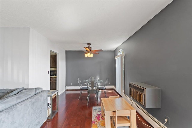 living room with baseboards, dark wood-style flooring, and ceiling fan