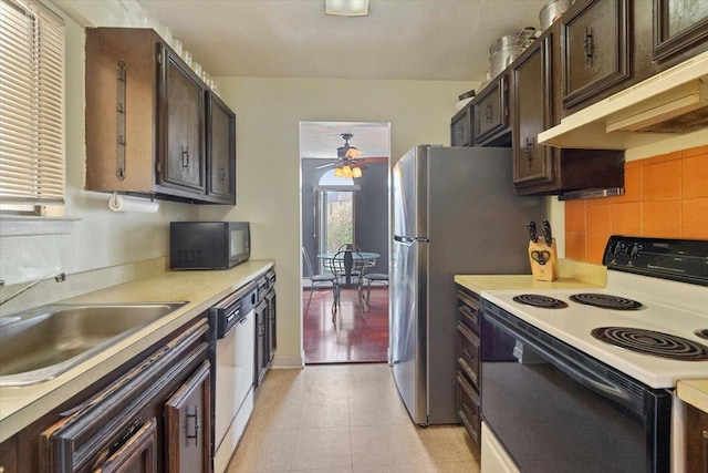 kitchen featuring electric range, under cabinet range hood, a sink, black microwave, and dishwasher