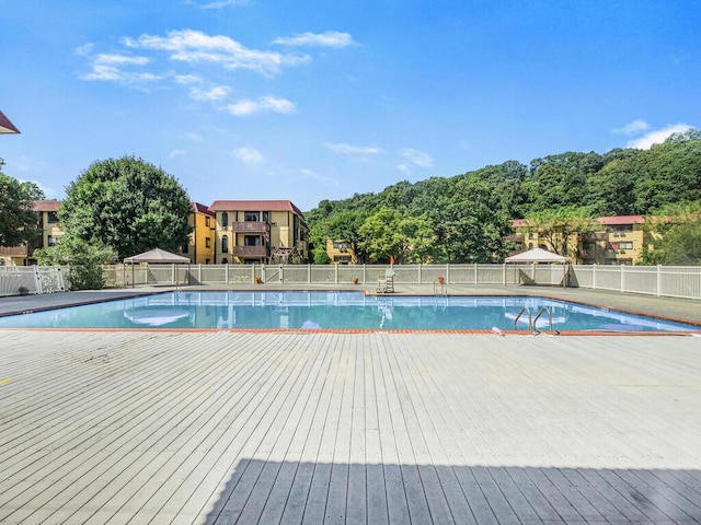 pool featuring a gazebo and fence