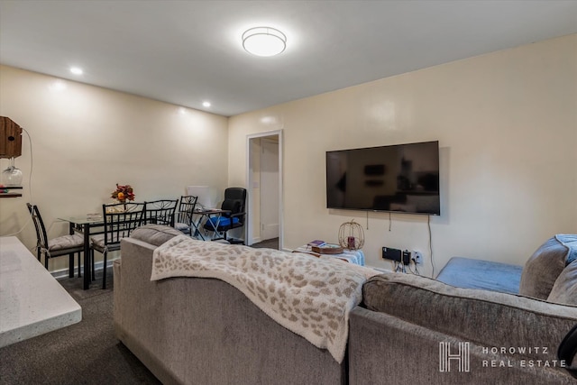 living room with recessed lighting and dark colored carpet