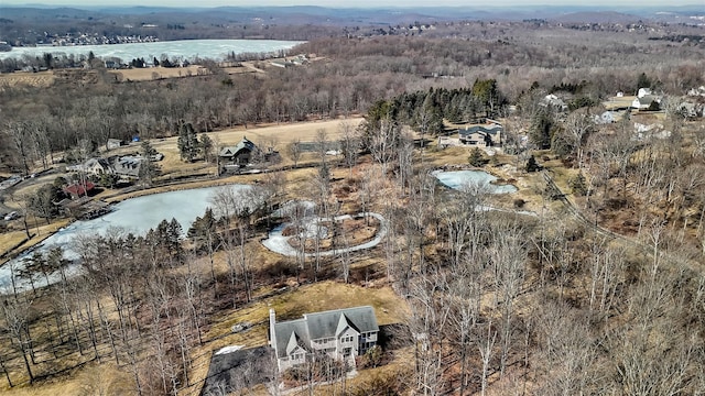 bird's eye view with a water view and a forest view