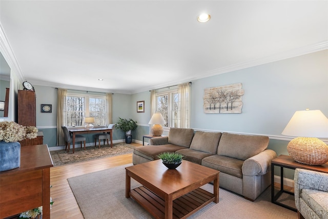 living room featuring crown molding, baseboards, light wood-type flooring, and recessed lighting