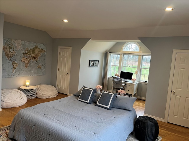 bedroom with light wood-style flooring, recessed lighting, and lofted ceiling