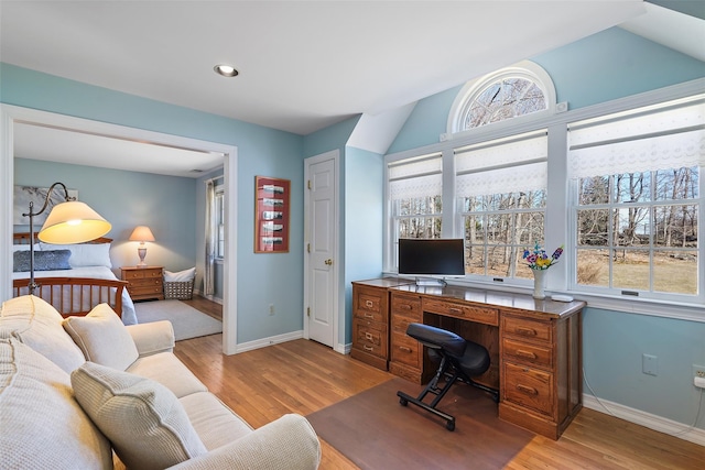 office area with light wood-style floors, baseboards, lofted ceiling, and recessed lighting